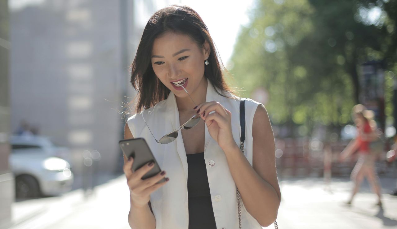 A traveler using a city-specific transit app at a metro station or bus stop.