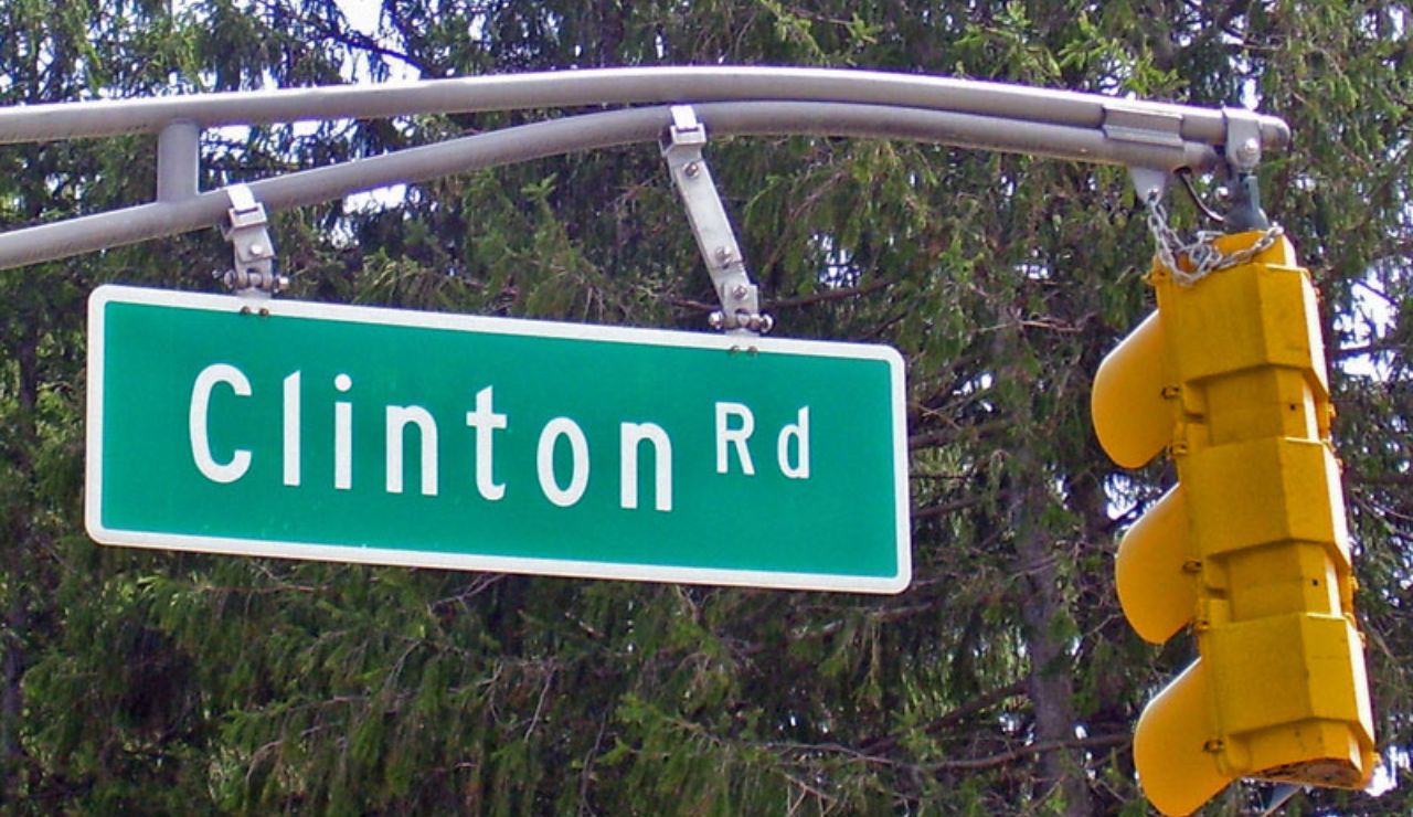 Clinton Road street sign mounted on a traffic light pole.