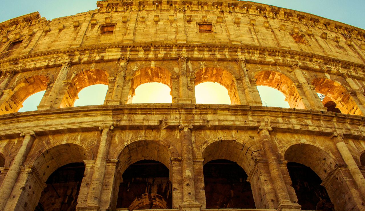 Sunlight shining through arches inside the Roman Colosseum