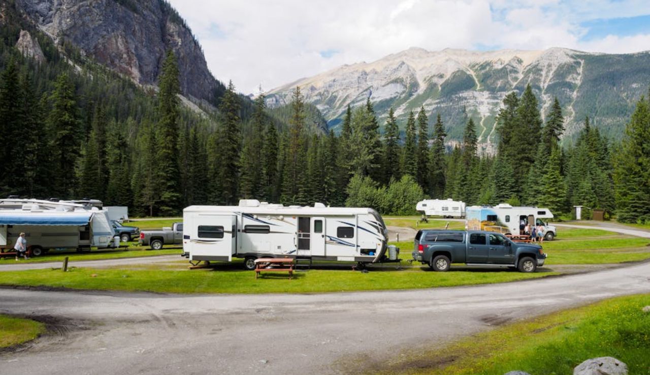 RVs and trucks parked at a scenic campground, showing the strong sense of RV community.