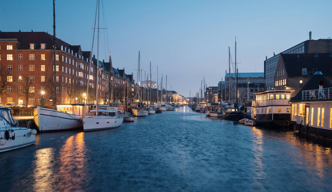 Colorful buildings and boats along Nyhavn harbor in Copenhagen.