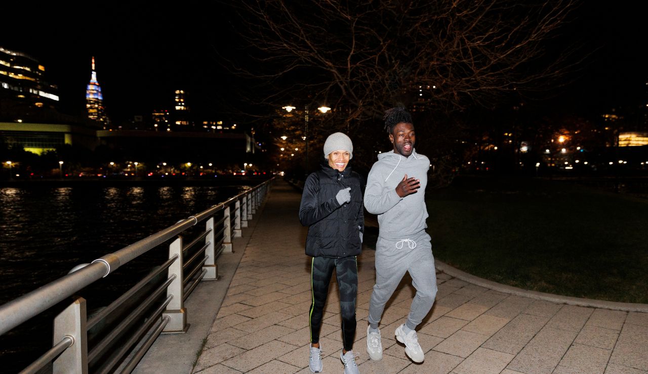 Couple changing direction on a dimly lit street at night