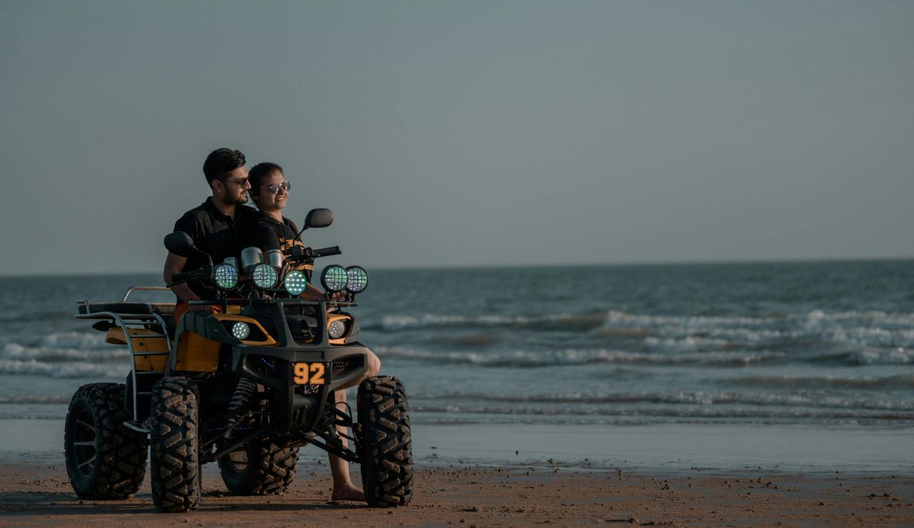 Couple biking together along A1A with ocean views and palm trees.