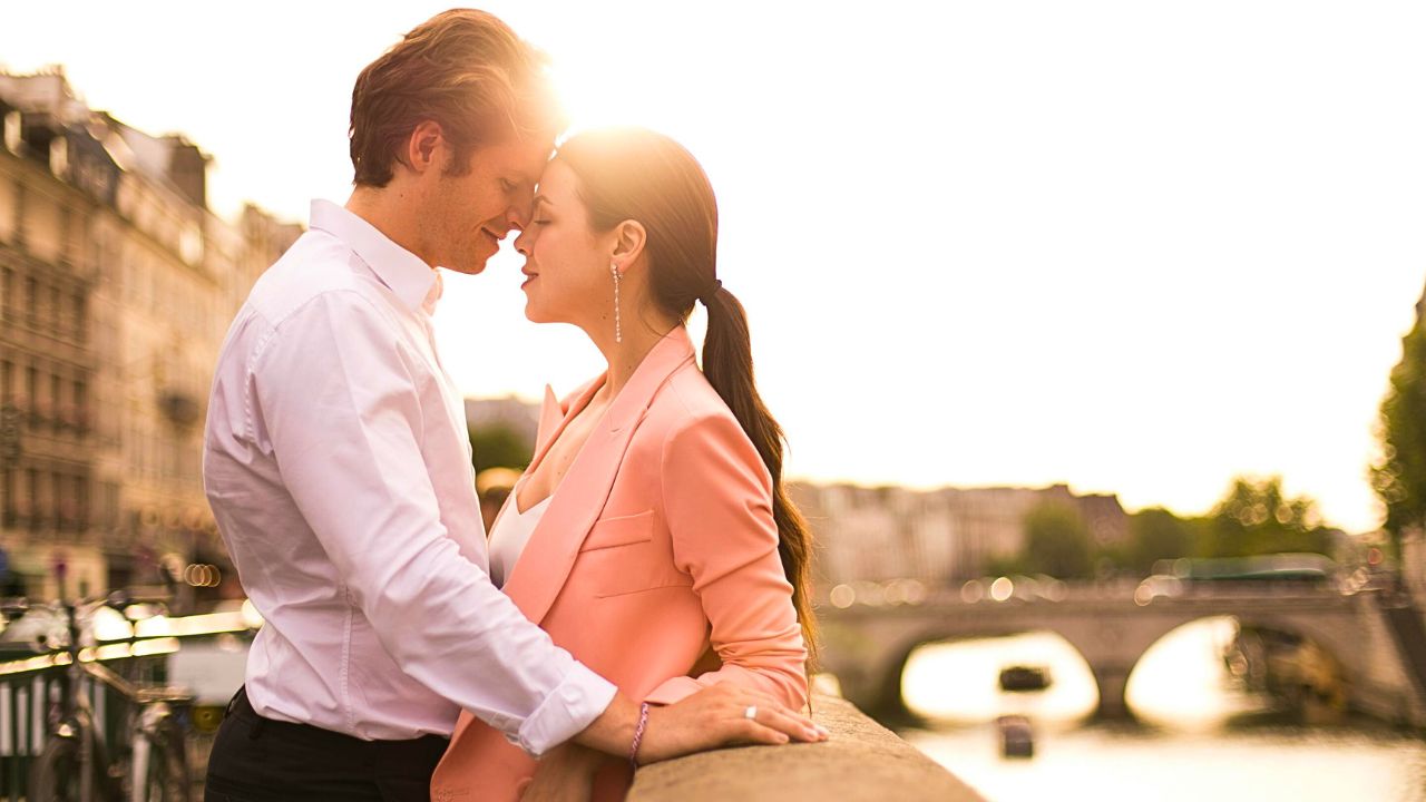 Couple enjoying a sunset in a romantic European city.