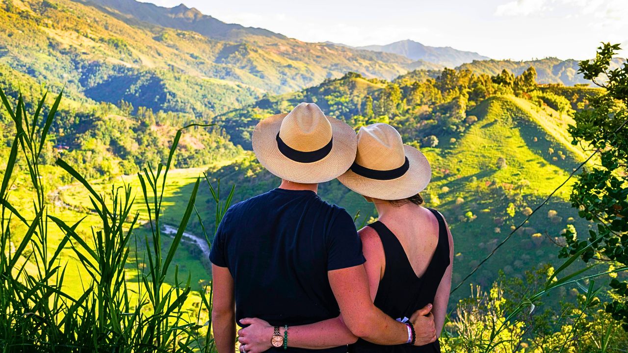 A couple hiking near a remote mountain, no phones in sight, soaking in the quiet.