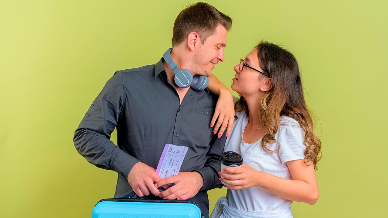 Couple staying comfortable during a long-haul flight with headphones and travel essentials