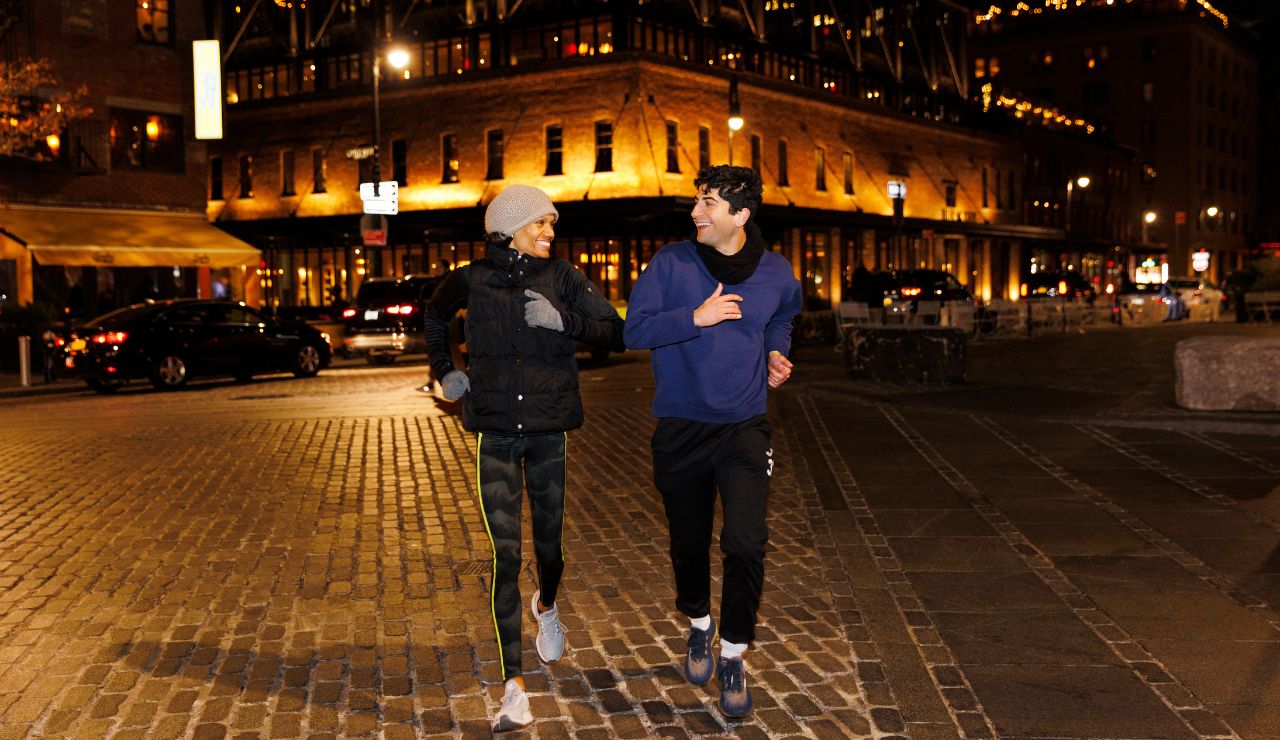 Couple walking under streetlights on a quiet, well-lit city path