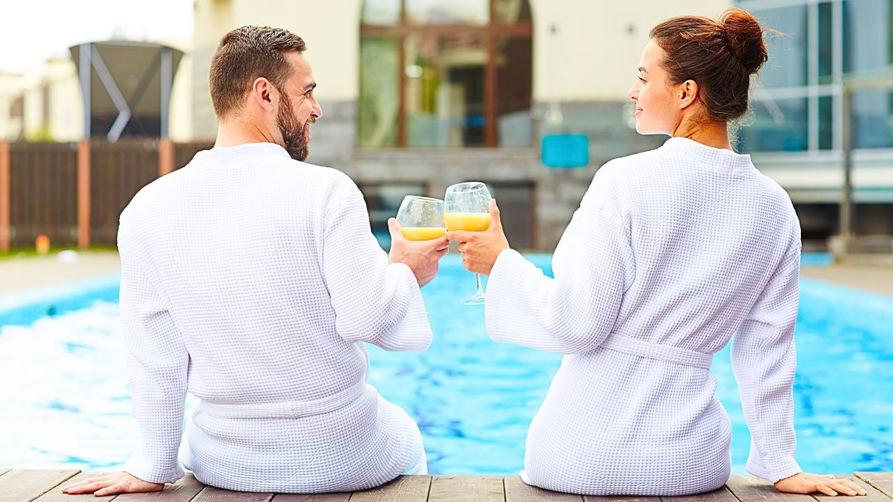 Couple enjoying drinks on a budget-friendly luxury getaway