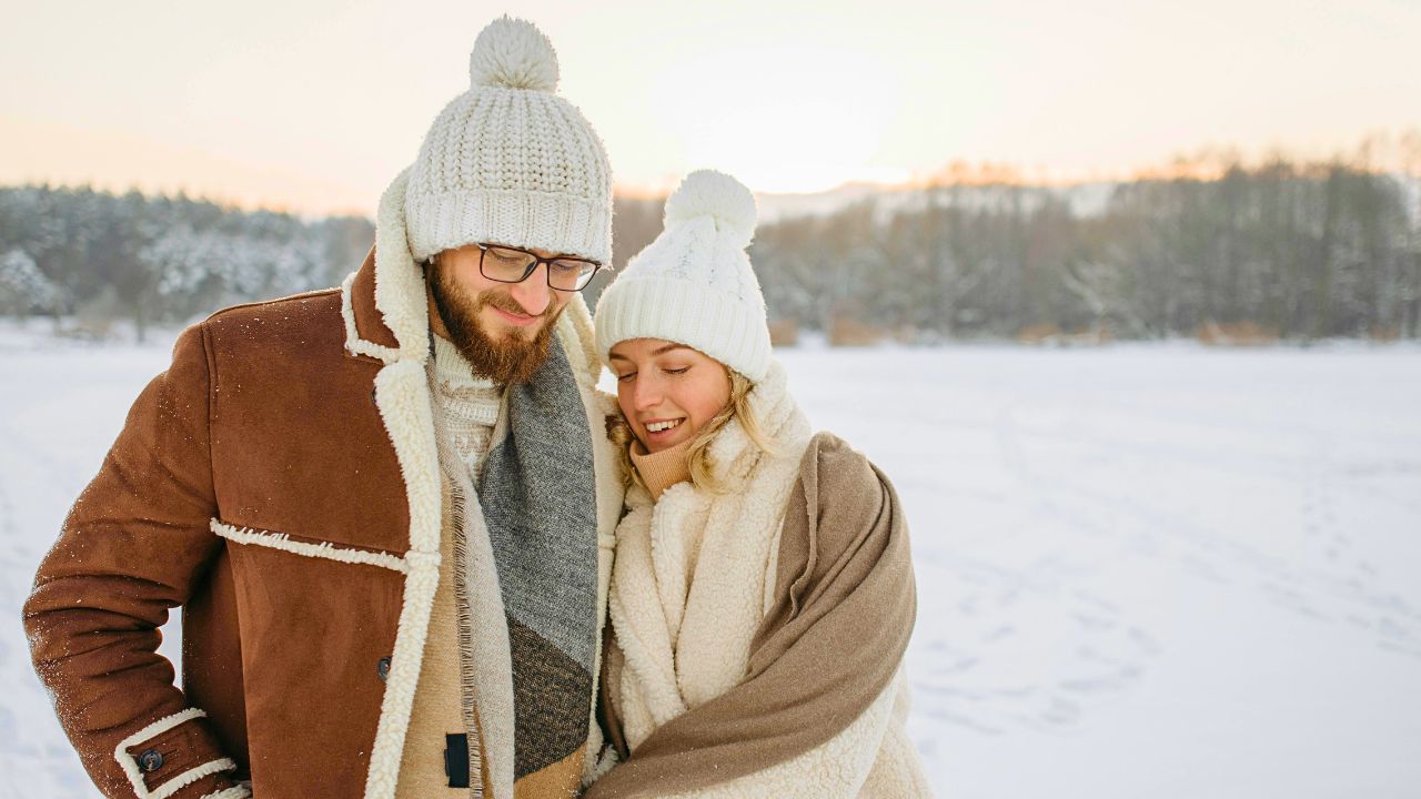Couple walking through a snowy village