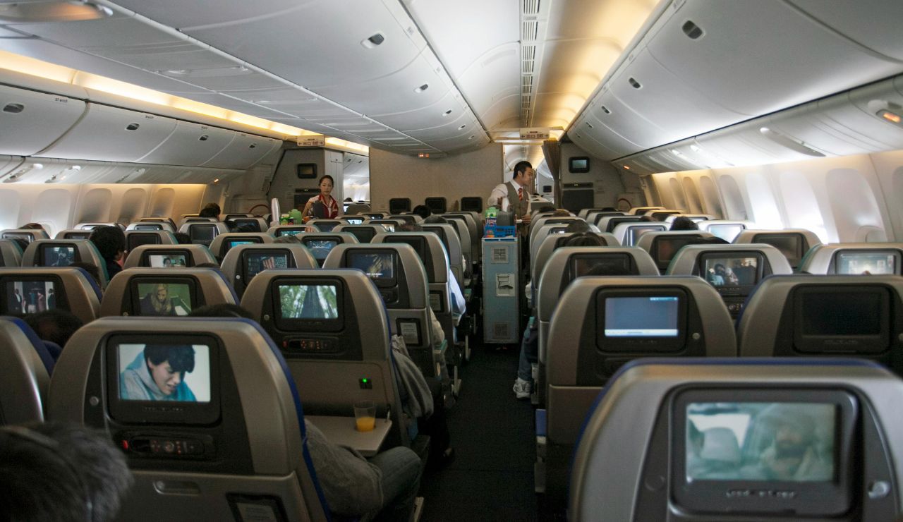 Passengers slouched in airplane seats during a long-haul flight