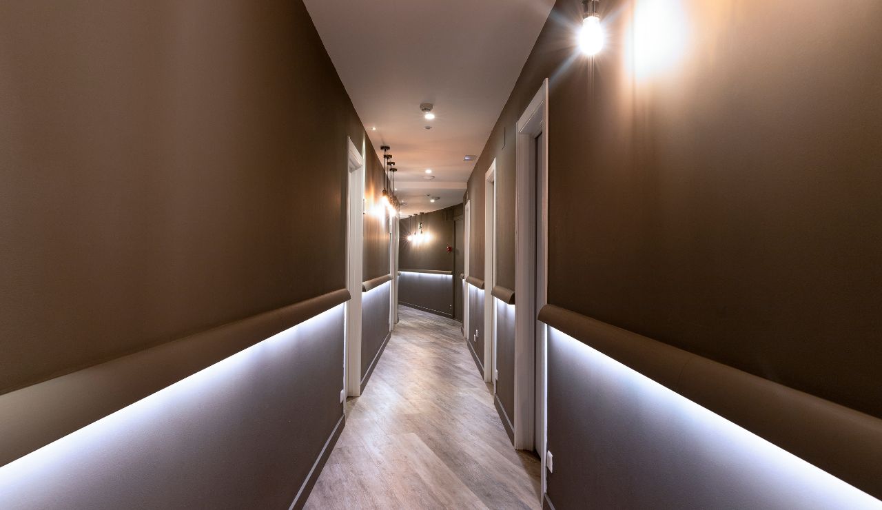 Interior hallway of a cruise ship with closed cabin doors and room numbers.