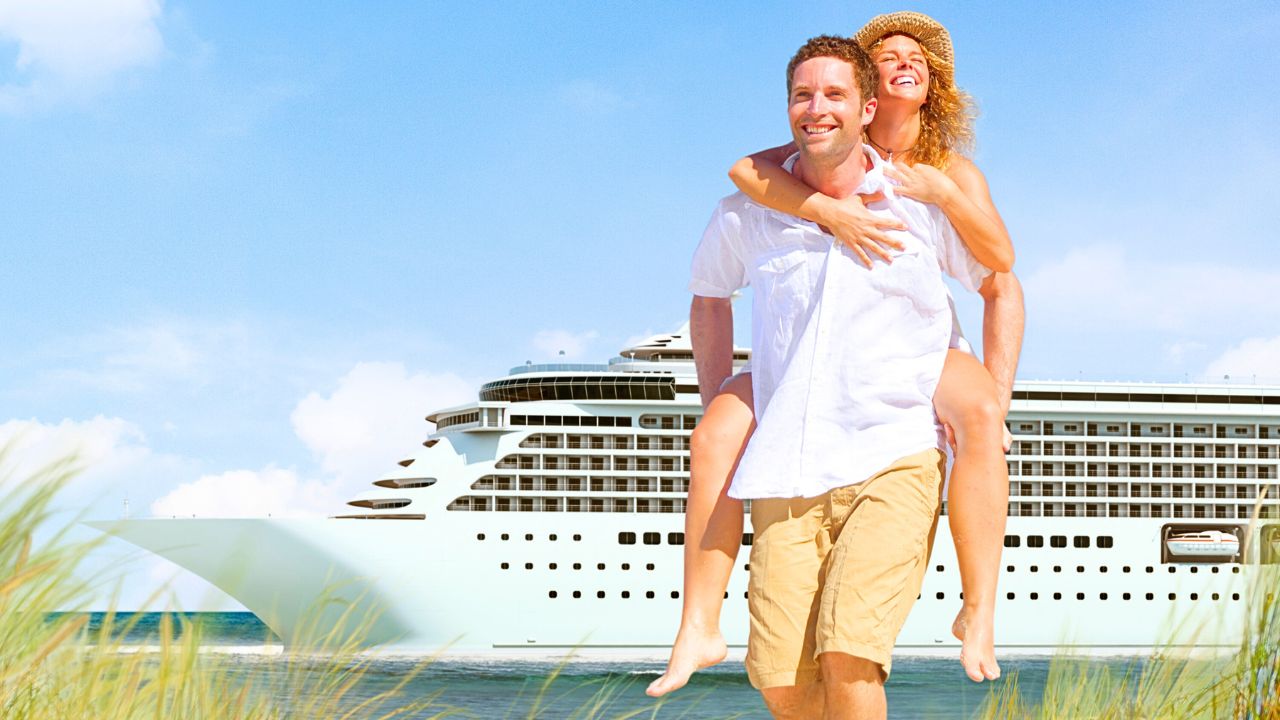 A couple standing near cruise ship enjoying views.