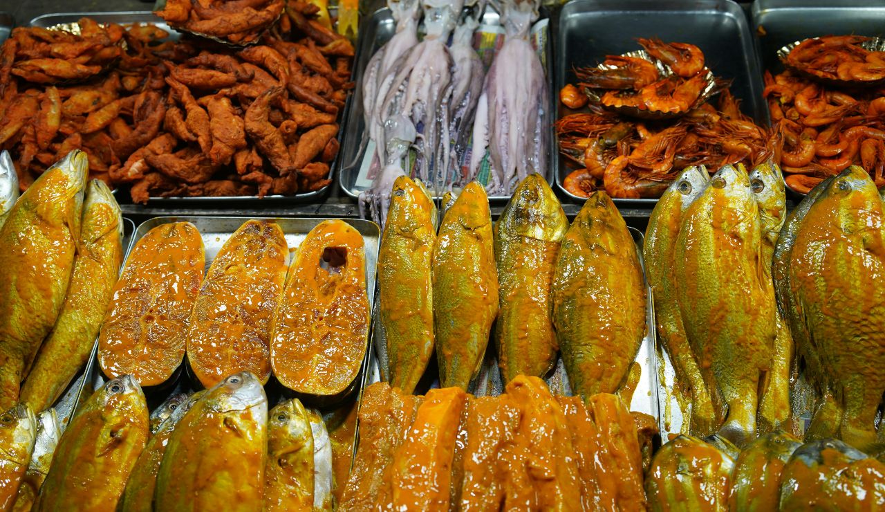 Variety of street snacks displayed in a Dhaka market
