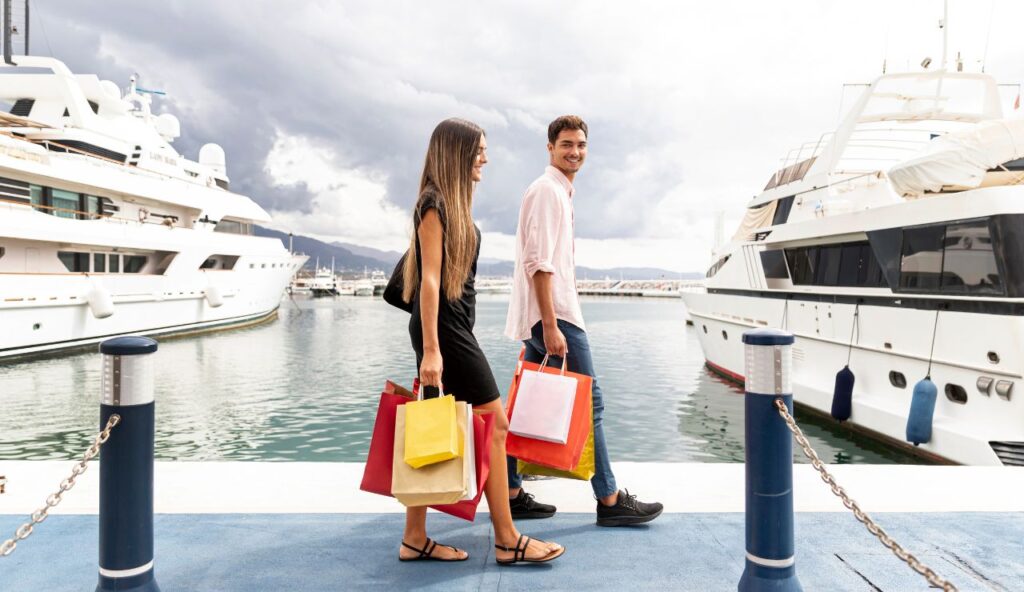 A couple dressed smartly, walking toward a cruise ship at embarkation.