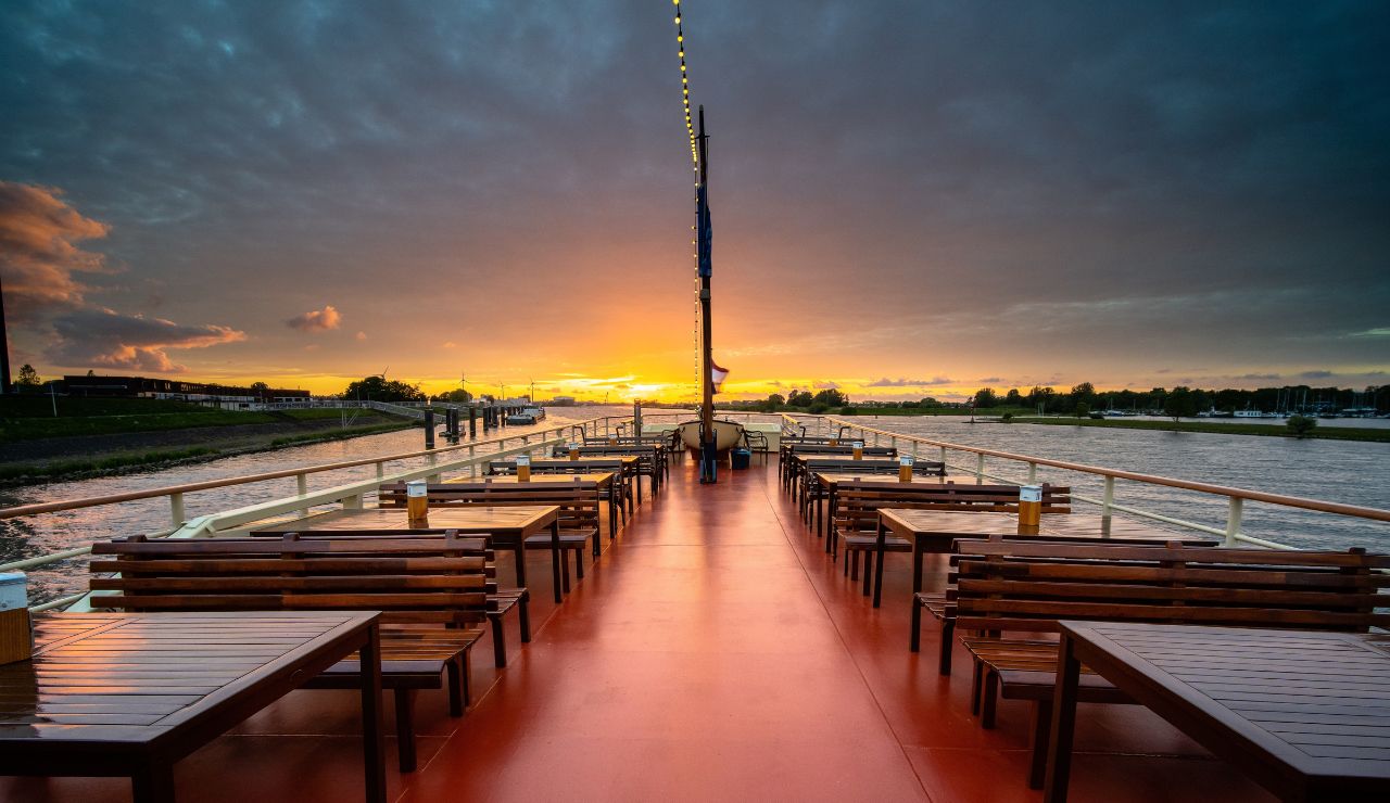 Nearly empty cruise ship deck with loungers and cloudy sky during off-peak season.