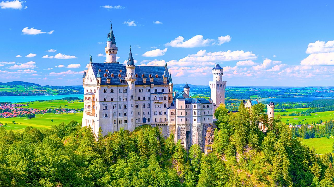 Romantic fairy-tale castle surrounded by misty mountains.