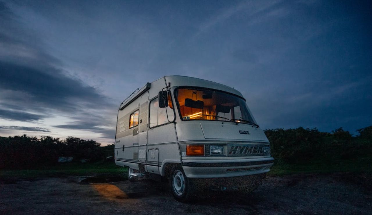 RV parked at dusk with lights on inside, symbolizing the freedom and compromises of life on the road.