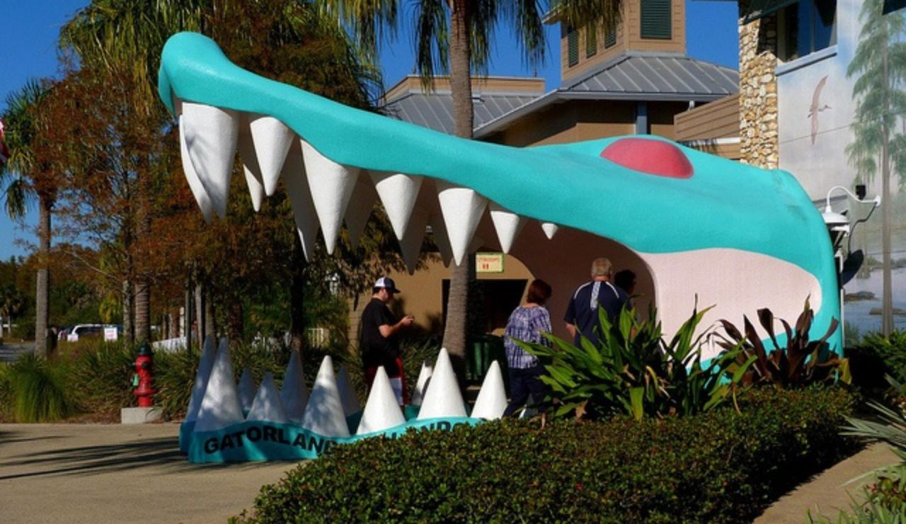 People entering a building through a giant alligator mouth entrance at Gatorland.