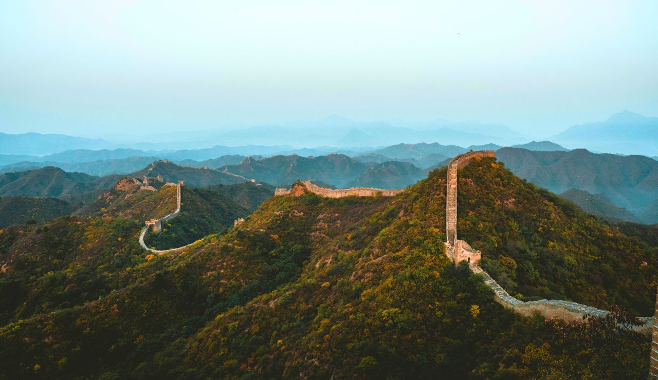 Great Wall of China winding over green hills
