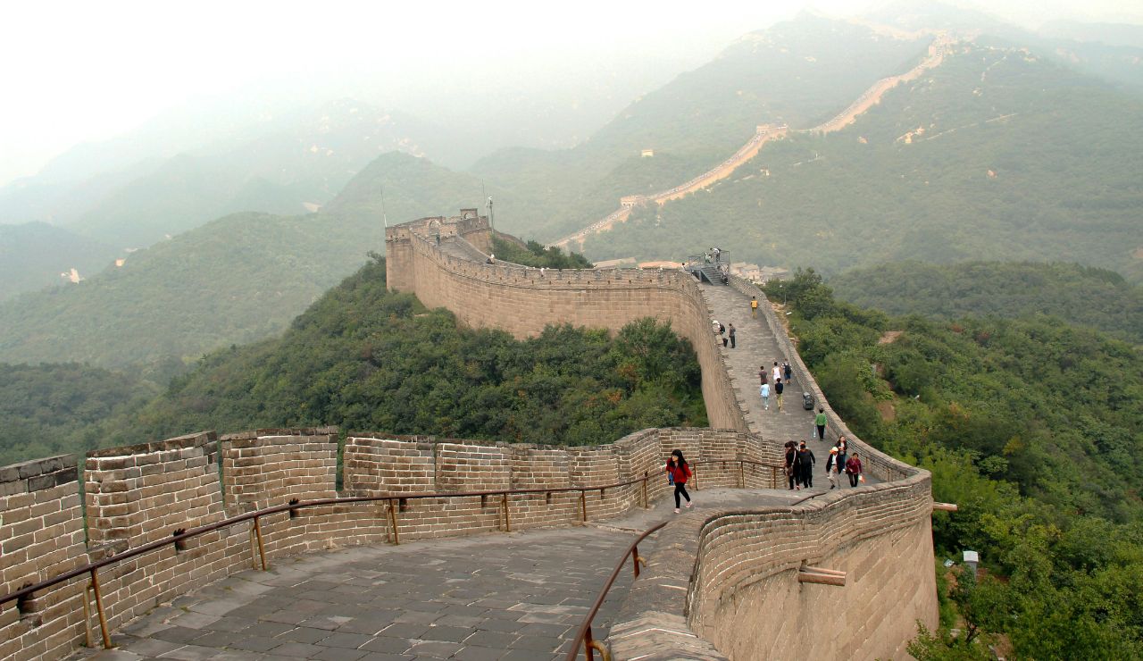 Great Wall of China winding over green hills.