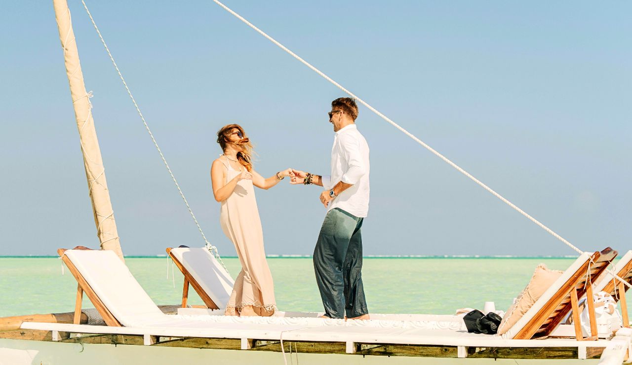 “Couple sailing the Greek Isles on a summer afternoon.”