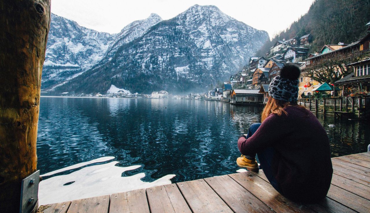 Visitors sitting in Hallstatt watching from lakeside viewpoint