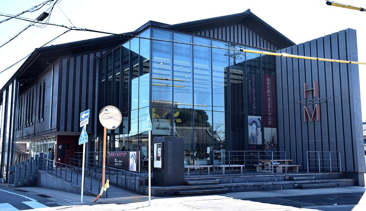 Modern building with large glass windows and a sign that reads "HM."