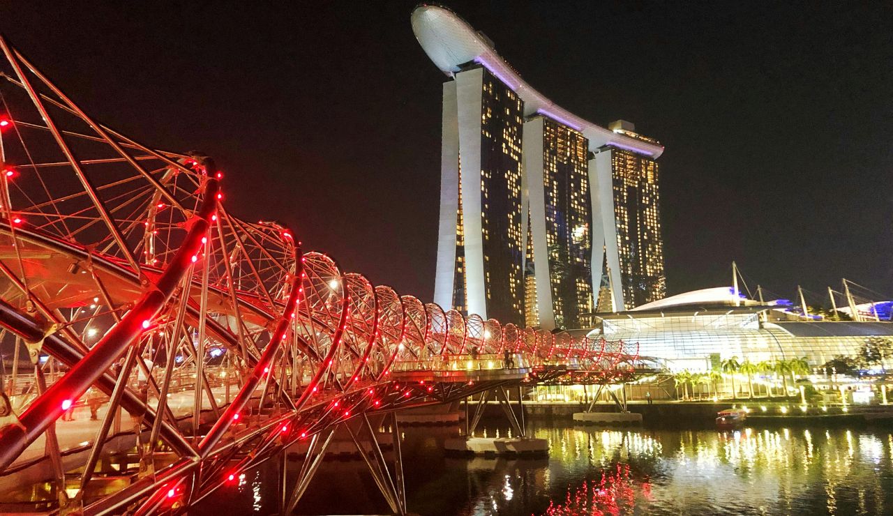 Sunset and lights on Helix Bridge in Singapore with skyline vie