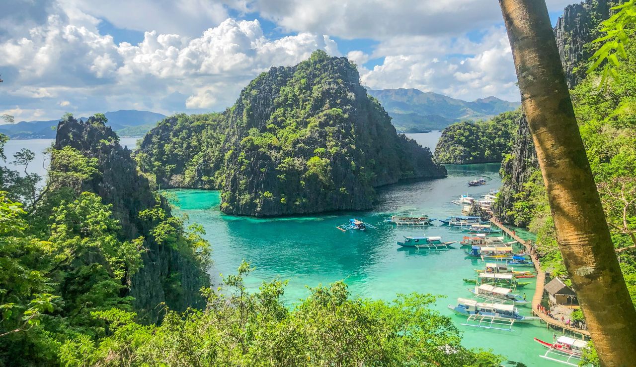 Hidden cove behind limestone cliffs with crystal-clear water.