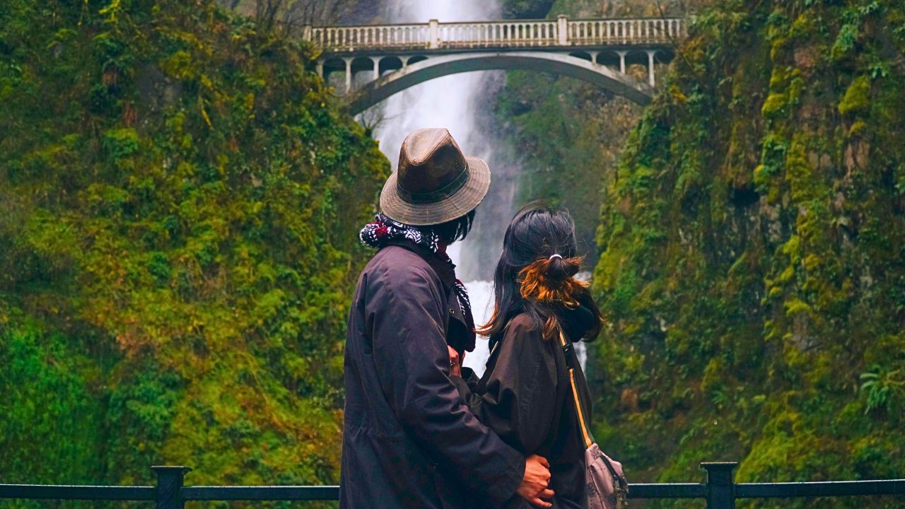 Couple overlooking a lush rainforest in Latin America