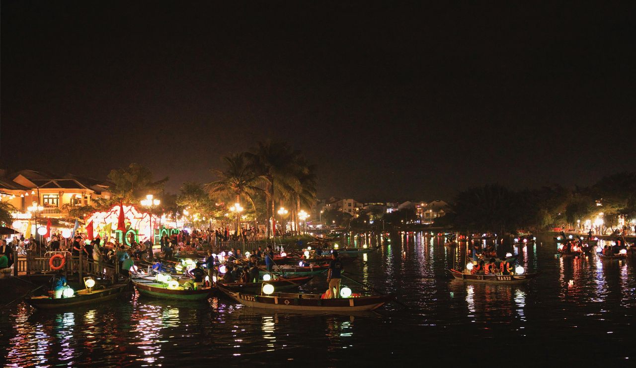  Lanterns floating on the river in Hoi An, creating a magical glow.