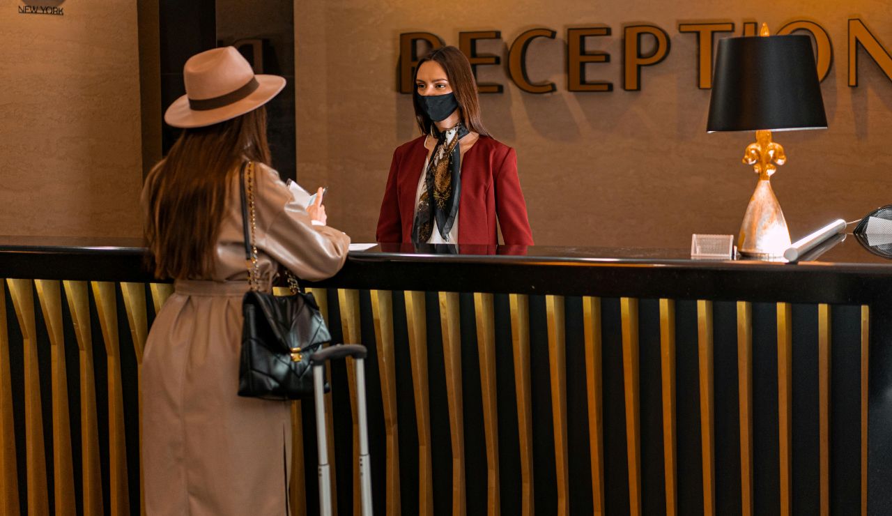 Travelers getting safety advice from a hotel concierge before heading out