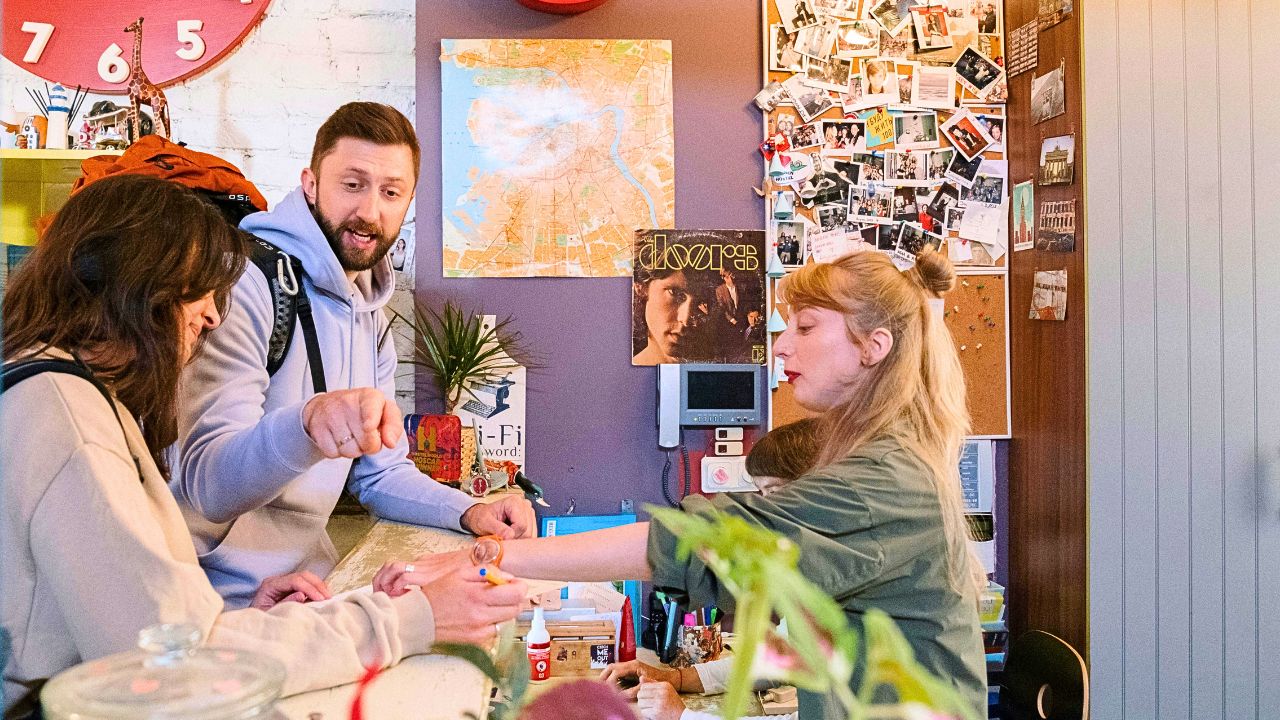 Couple checking in at a hotel front desk
