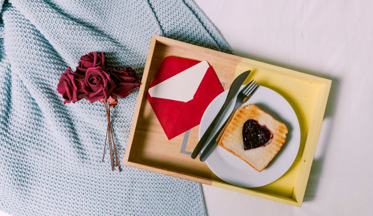 A breakfast tray in bed with a note that says “included” or “on the house.”