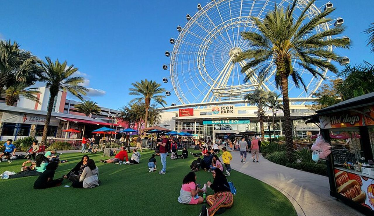 Visitors relaxing near the Ferris wheel at ICON Park in Orlando, Florida.