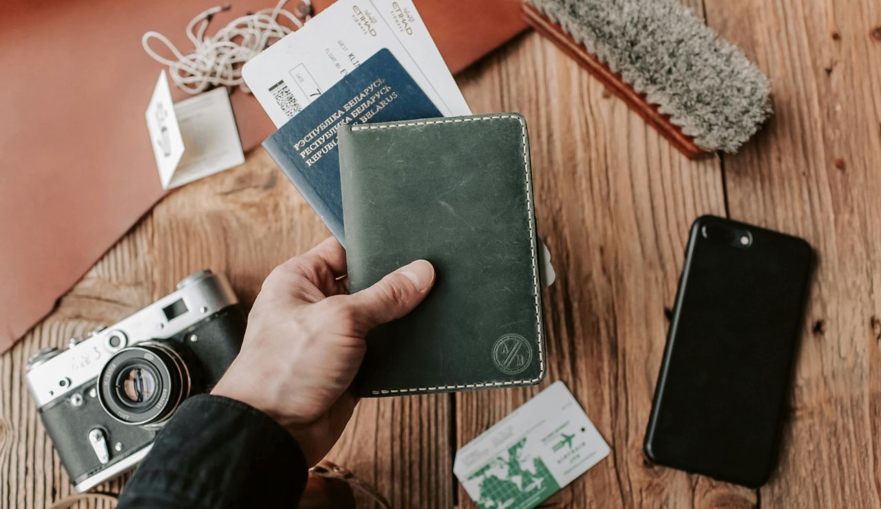 Person holding ID and boarding pass in hand at airport line