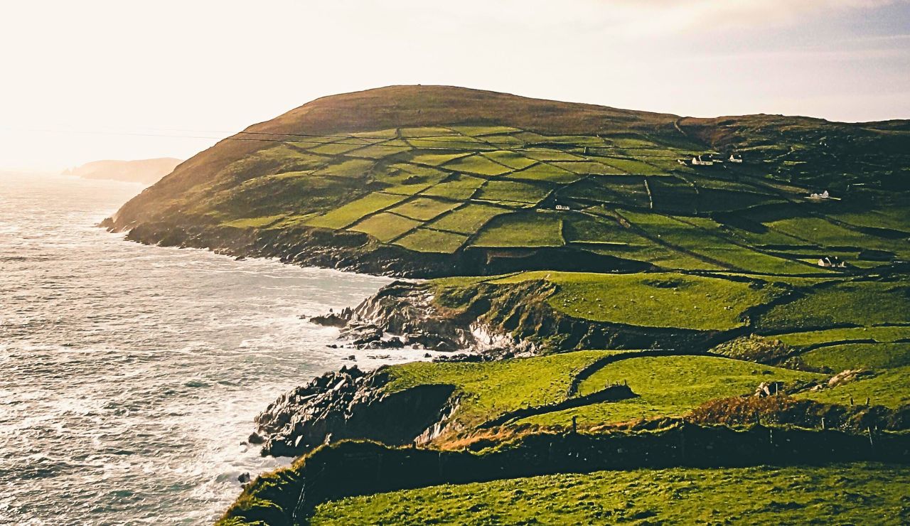 Windswept coastline and green hills on Inishbofin Island, Ireland