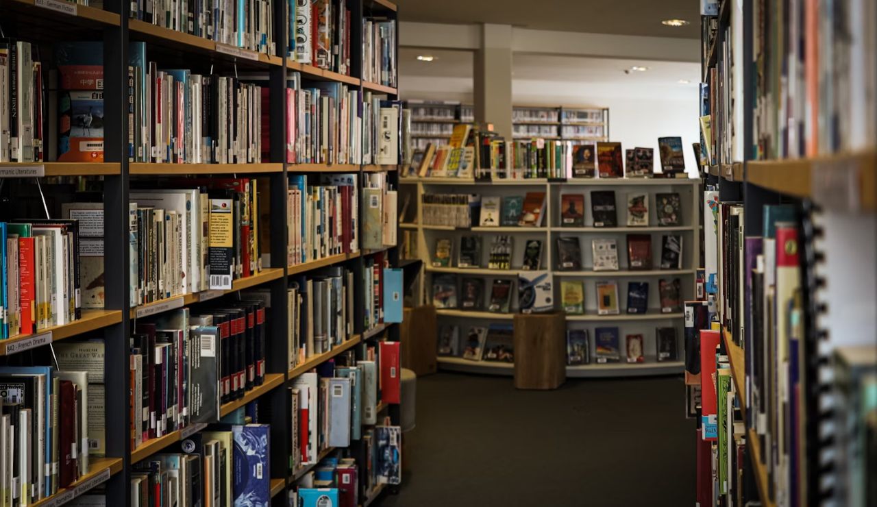 Rows of bookshelves in a quiet, modern library, representing the Pacific Northwest’s dedication to education and creative culture.