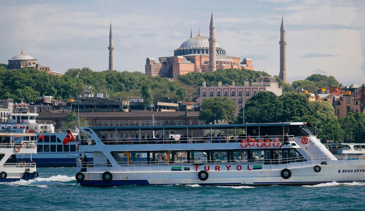 Ferry crossing the Bosphorus with Hagia Sophia in the skyline.