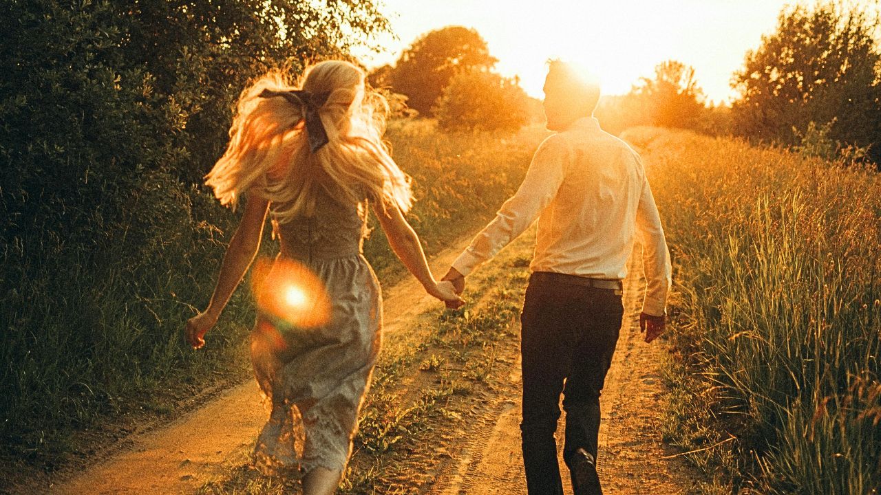 Couple walking through a quiet historic Italian town at sunset