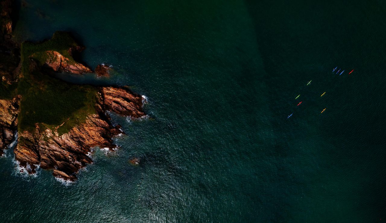 Kayakers exploring sea caves off the coast of La Jolla
