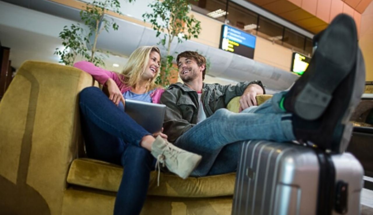 Couple sitting peacefully near a window during an airport layover