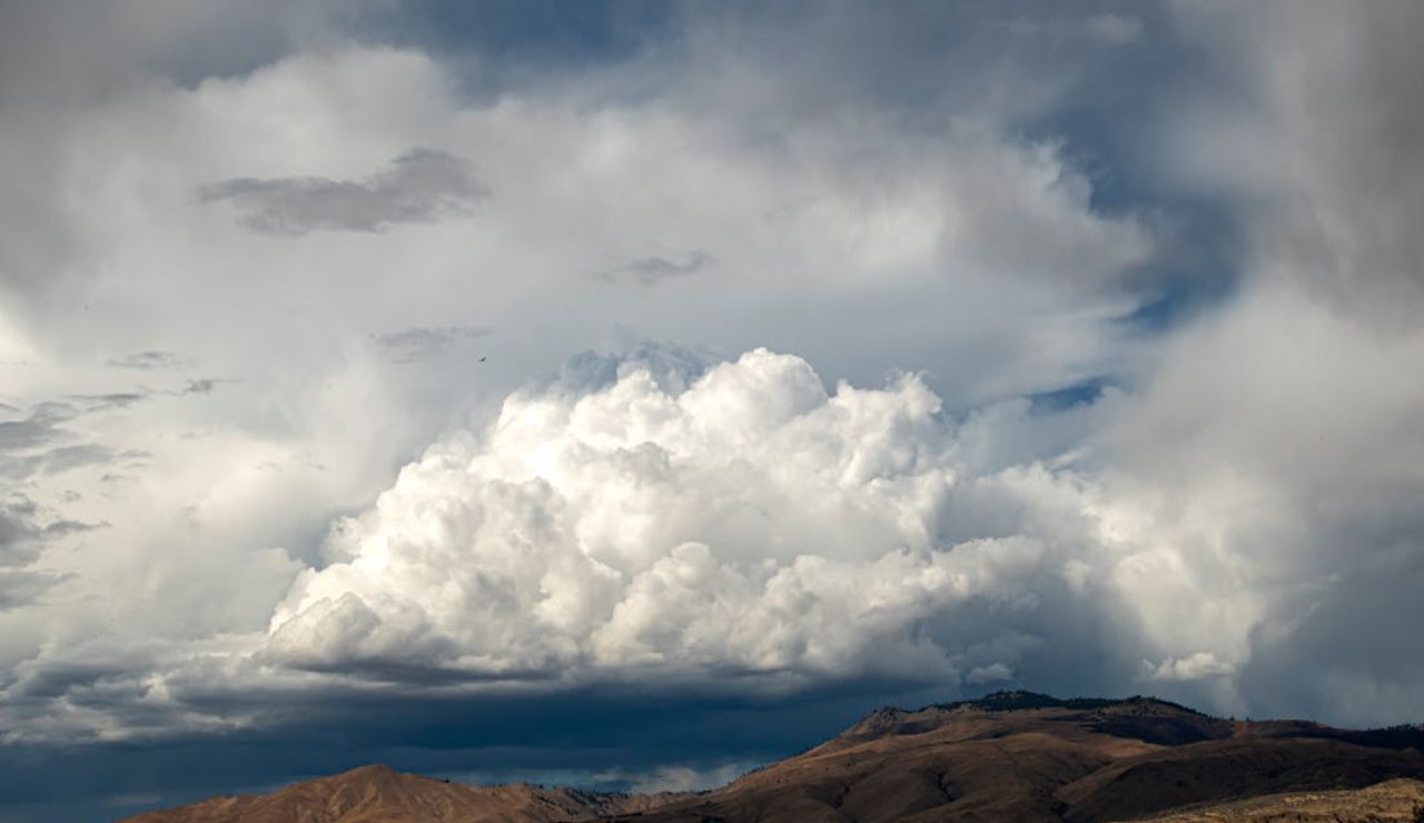 Thick clouds gathering over dry hills, reflecting the limited sunshine and short winter days in the Pacific Northwest.