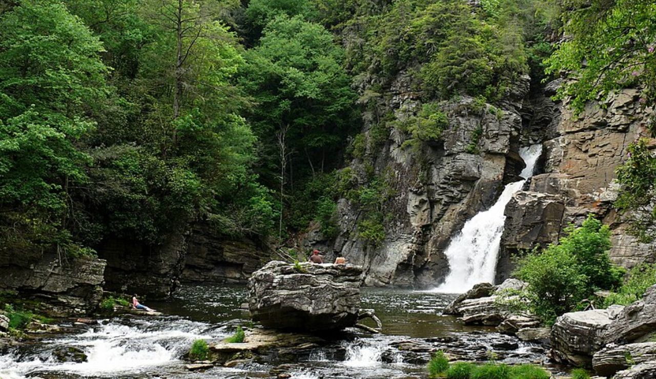 Waterfall flowing through rocky cliffs and forest at Linville Gorge in North Carolina.