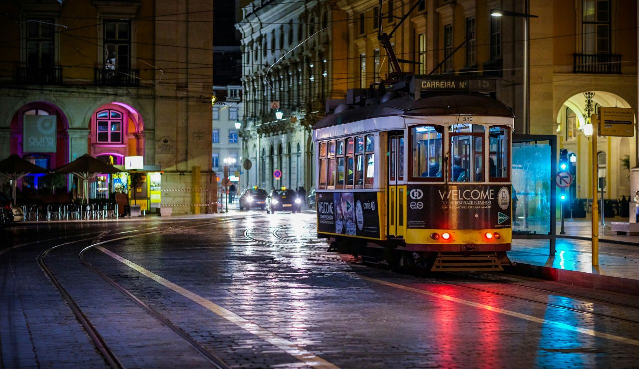  Iconic yellow tram passing through Lisbon’s cobblestone streets.