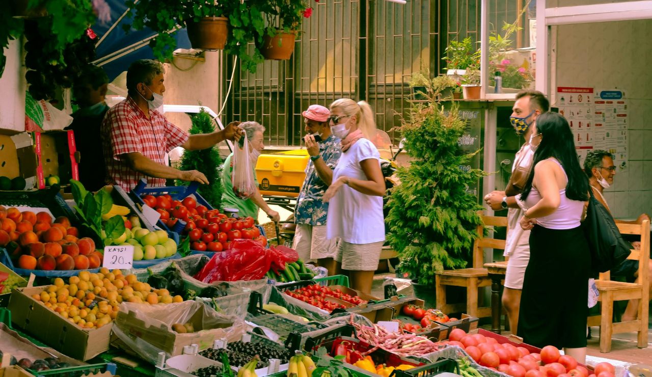 A vibrant local market with fresh produce, handmade items, and colorful displays.