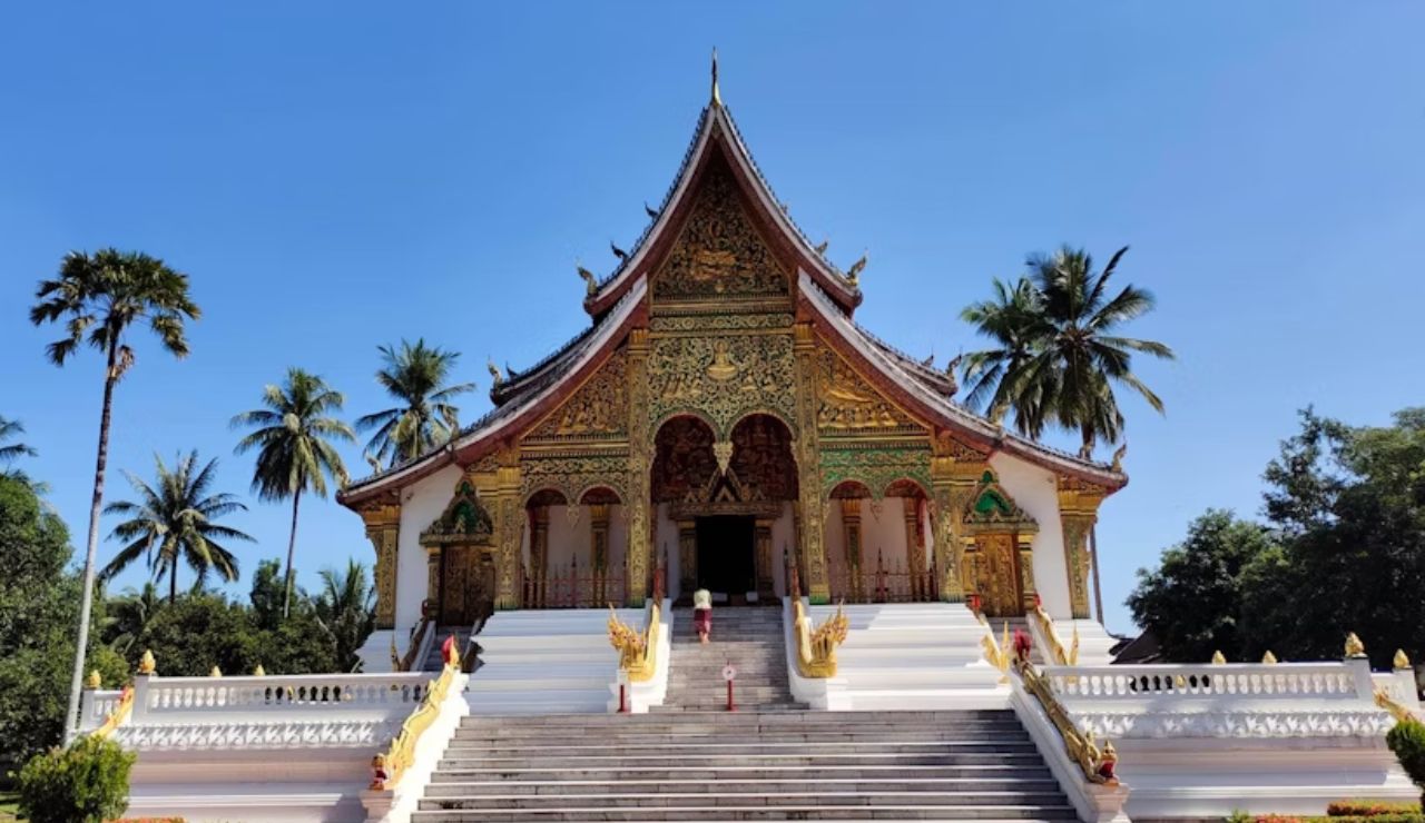 This is the Royal Palace Temple (Haw Pha Bang) in Luang Prabang, Laos — a stunning example of traditional Lao architecture with intricate gold detailing.