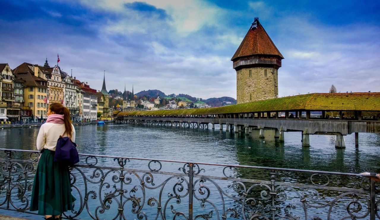 Chapel Bridge crossing Lake Lucerne with mountains in the background.