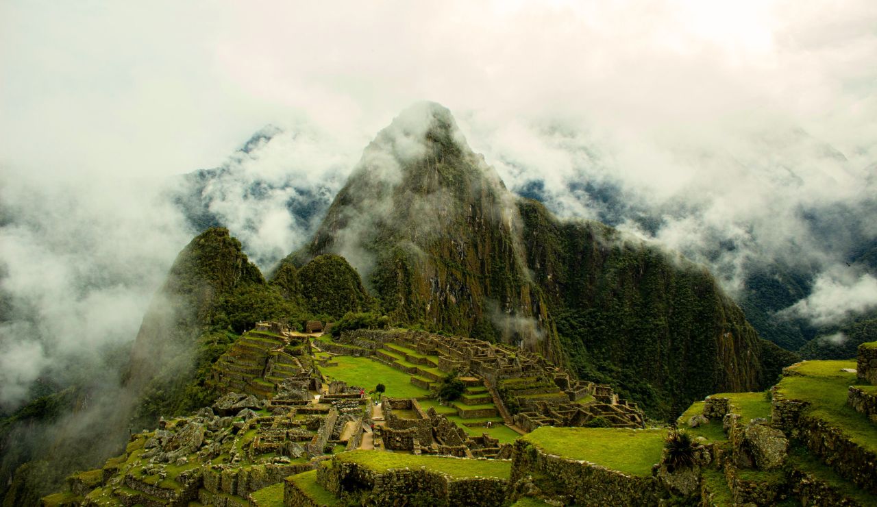  Mist-covered stone terraces of Machu Picchu with mountain backdrop