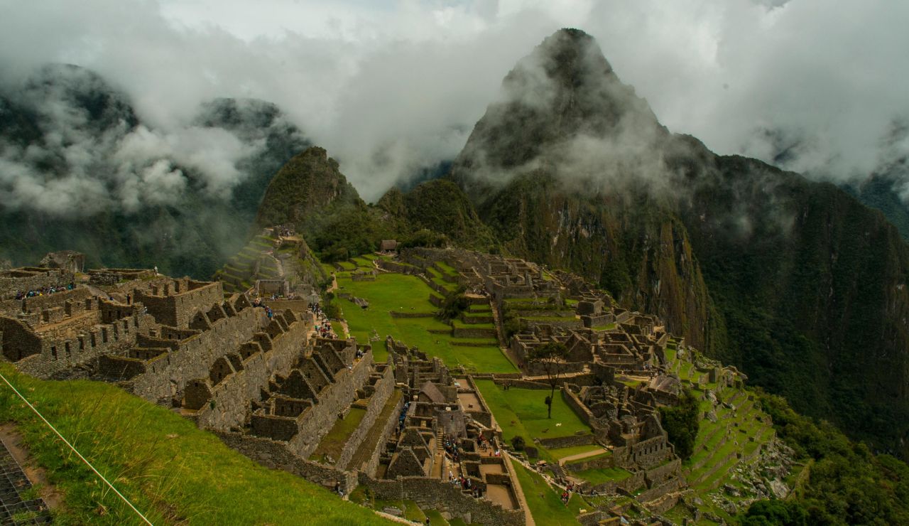 Ancient stone terraces and peaks of Machu Picchu under morning mist